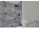 Modern shower featuring gray tiling, rainfall shower head and handheld shower at 96 Saint Johns Wood Ave, Henderson, NV 89002