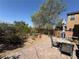 Backyard featuring a brick paver patio, mature landscaping, and a peaceful outdoor seating area at , Las Vegas, NV 89179