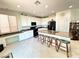 Bright kitchen featuring granite countertops, black appliances, and a spacious center island with bar seating at , Las Vegas, NV 89179