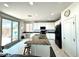 Bright kitchen showcasing a center island with granite counters, black appliances, and sliding door access to the backyard at , Las Vegas, NV 89179