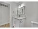 A renovated bathroom features a modern vanity with a new faucet and a hanging mirror at 101 N 19Th St, Las Vegas, NV 89101