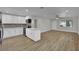 A bright and airy kitchen features stainless steel appliances, white cabinets, and wood-look flooring at 101 N 19Th St, Las Vegas, NV 89101
