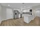 A modern kitchen features stainless steel appliances, white cabinets, and wood-look flooring at 101 N 19Th St, Las Vegas, NV 89101
