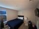 Cozy bedroom with a full bed, window with blinds, ceiling light, neutral-colored walls, and gray carpeting at 10163 Kings Amethyst St, Las Vegas, NV 89141
