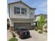 Two-story home featuring a two-car garage, stone accents, a tiled roof, and a paved driveway with nice landscaping at 10163 Kings Amethyst St, Las Vegas, NV 89141