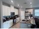 Spacious kitchen with modern white cabinets, stainless steel appliances, granite countertops, and a center island with seating at 10163 Kings Amethyst St, Las Vegas, NV 89141