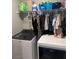 Efficient laundry room featuring a modern washer and dryer with convenient shelving for storage at 10163 Kings Amethyst St, Las Vegas, NV 89141