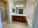 Bright bathroom with double sinks, shower, and separate bathtub at 1169 Via Piazza, Henderson, NV 89052