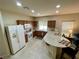 Well-lit kitchen featuring tile floors, wooden cabinets, and modern appliances at 1169 Via Piazza, Henderson, NV 89052