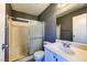 Bathroom featuring a shower-tub combo with a sliding glass door and a standard white sink and cabinet at 1480 Hialeah Dr # B, Las Vegas, NV 89119