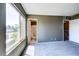 Upstairs bedroom featuring a large window for lots of natural light and access to an ensuite bathroom at 1480 Hialeah Dr # B, Las Vegas, NV 89119