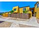 Charming yellow townhouse with a private fenced yard and well-manicured landscaping at 1480 Hialeah Dr # B, Las Vegas, NV 89119