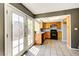 The open-concept kitchen and dining area offers wood cabinets, black appliances, tile floors, and easy access to the backyard at 1480 Hialeah Dr # B, Las Vegas, NV 89119