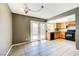 Open kitchen and dining space with tile floors, French doors to backyard, wood cabinets, and backyard view at 1480 Hialeah Dr # B, Las Vegas, NV 89119