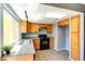 Charming kitchen boasts granite countertops, wood cabinets, black appliances, and tile flooring at 1480 Hialeah Dr # B, Las Vegas, NV 89119