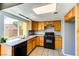 Bright kitchen with granite countertops, stainless steel sink, black appliances, light blue walls and backyard window view at 1480 Hialeah Dr # B, Las Vegas, NV 89119