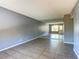 Bright living room with tile flooring and large mirror wall reflects natural light from the back door at 1480 Hialeah Dr # B, Las Vegas, NV 89119