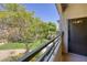 Balcony view of lush green common area with mature trees and nearby walking paths at 1705 King James St # 203, Las Vegas, NV 89144