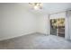 Neutral bedroom featuring plush carpet flooring, ceiling fan, private balcony access and lots of bright, natural light at 1705 King James St # 203, Las Vegas, NV 89144