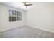 Simple bedroom featuring plush carpet flooring, ceiling fan, closet and bright, neutral walls at 1705 King James St # 203, Las Vegas, NV 89144