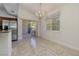 Dining area with modern chandelier, leading to outdoor balcony through sliding glass doors at 1705 King James St # 203, Las Vegas, NV 89144