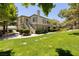 Beautiful exterior of the property showcasing lush green grass and mature trees at 1705 King James St # 203, Las Vegas, NV 89144