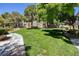 Well-maintained lawn with mature trees and manicured landscaping at 1705 King James St # 203, Las Vegas, NV 89144
