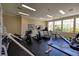 A community gym with large windows, including cardio machines, weight equipment, and ample workout space at 1705 King James St # 203, Las Vegas, NV 89144