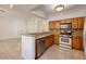 Well-lit kitchen featuring stainless steel appliances, granite counters and tile flooring at 1705 King James St # 203, Las Vegas, NV 89144