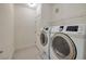 Well-lit laundry room equipped with a side-by-side washer and dryer at 1705 King James St # 203, Las Vegas, NV 89144