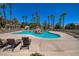Resort-style pool and lounge seating with mature palm trees at 1705 King James St # 203, Las Vegas, NV 89144