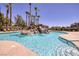 Resort-style pool with rock waterfall feature and palm trees at 1705 King James St # 203, Las Vegas, NV 89144