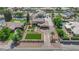 An aerial shot showcases a large home with lush lawns, a long driveway, and desert landscaping at 1919 Belcastro St, Las Vegas, NV 89117