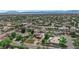 Expansive aerial view of a residential neighborhood with lush landscaping, swimming pools, and mountain views in the distance at 1919 Belcastro St, Las Vegas, NV 89117