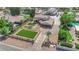 Aerial view of a luxurious home with lush lawns, mature trees, long driveway and desert landscaping at 1919 Belcastro St, Las Vegas, NV 89117
