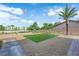 Well-manicured backyard with a putting green, cacti, and palm trees, perfect for relaxation and outdoor activities at 1919 Belcastro St, Las Vegas, NV 89117