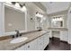 Bright bathroom featuring a double vanity with granite countertops and white cabinets at 1919 Belcastro St, Las Vegas, NV 89117