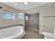 Bathroom features a relaxing jacuzzi tub, glass shower, and plenty of natural light at 1919 Belcastro St, Las Vegas, NV 89117