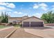 Inviting two-story home with a three-car garage and desert landscaping providing great curb appeal at 1919 Belcastro St, Las Vegas, NV 89117