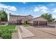 Beautiful two-story home showcasing lush landscaping, a paved driveway, and a two-car garage at 1919 Belcastro St, Las Vegas, NV 89117