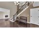 Elegant foyer featuring hardwood floors, a staircase, and access to a living room with a fireplace at 1919 Belcastro St, Las Vegas, NV 89117