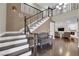 Inviting foyer features hardwood floors, a staircase with wrought iron railing, and views of the living area at 1919 Belcastro St, Las Vegas, NV 89117
