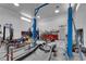 Well-lit garage interior equipped with a car lift and workbenches for car repair and maintenance at 1919 Belcastro St, Las Vegas, NV 89117