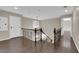 Hallway features dark hardwood floors, an iron railing, and plenty of natural light at 1919 Belcastro St, Las Vegas, NV 89117