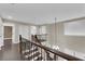 Hallway boasts dark hardwood floors and decorative iron railing overlooking a sunlit living area at 1919 Belcastro St, Las Vegas, NV 89117