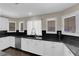 Kitchen featuring white cabinets, black countertop, stainless steel appliances and island cooktop at 1919 Belcastro St, Las Vegas, NV 89117
