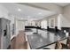 Well-lit kitchen with white cabinets, black countertops, and a stainless steel refrigerator at 1919 Belcastro St, Las Vegas, NV 89117