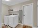 Functional laundry room featuring a washer, dryer, and shelving at 1919 Belcastro St, Las Vegas, NV 89117