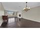 Bright living room featuring a white brick fireplace, chandelier and large window at 1919 Belcastro St, Las Vegas, NV 89117