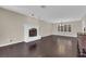 Bright living room featuring a white brick fireplace and dark wood flooring at 1919 Belcastro St, Las Vegas, NV 89117